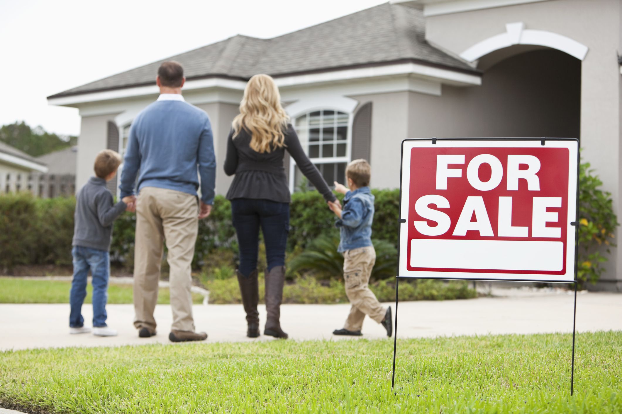 family-looking-at-house-for-sale-58017e4c3df78cbc28251a41