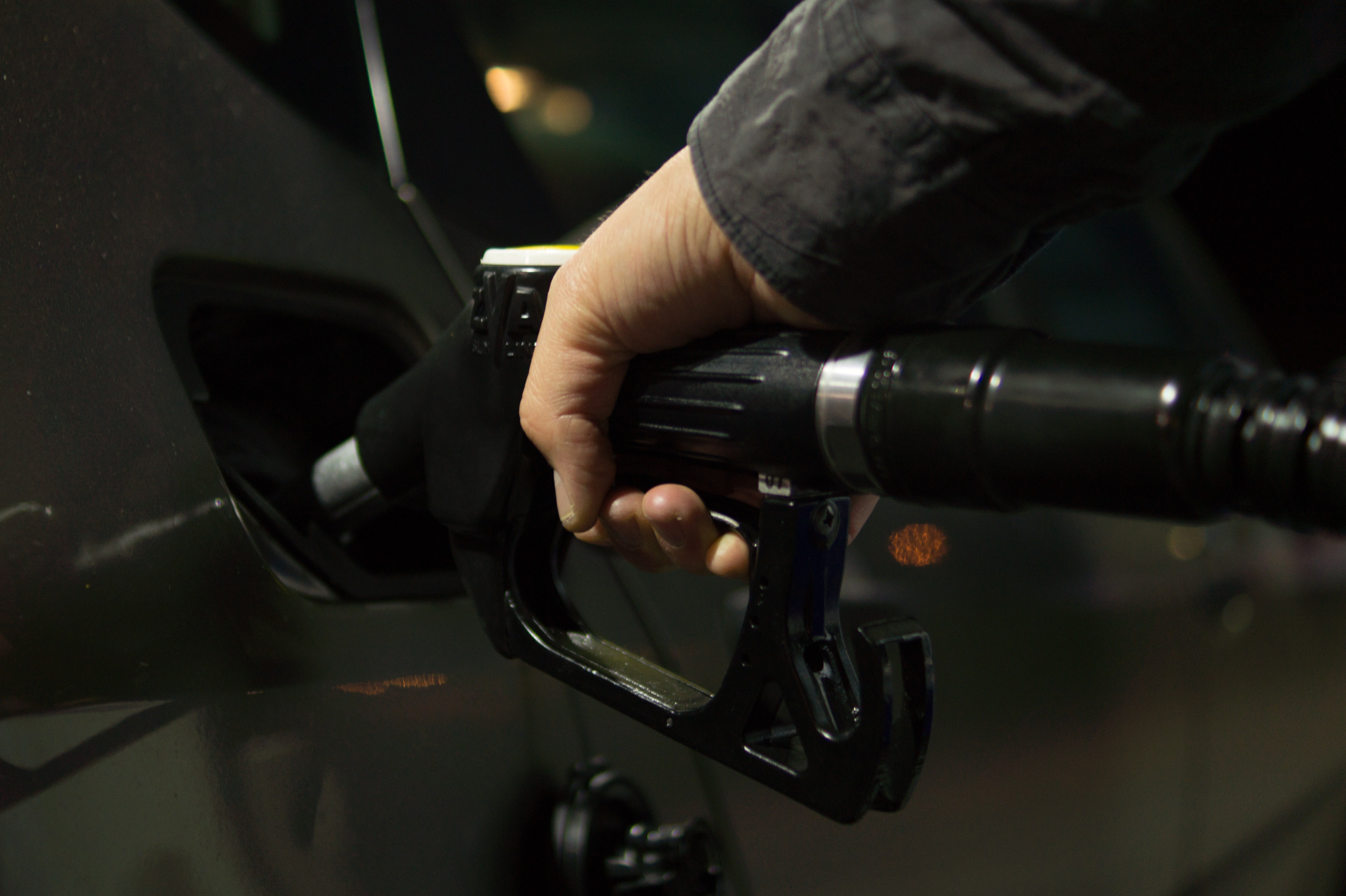 A person pumping gas.