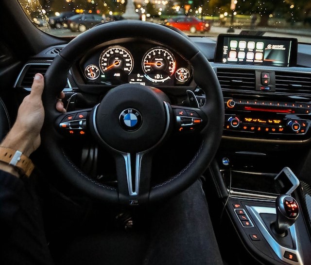 A person driving a BMW.